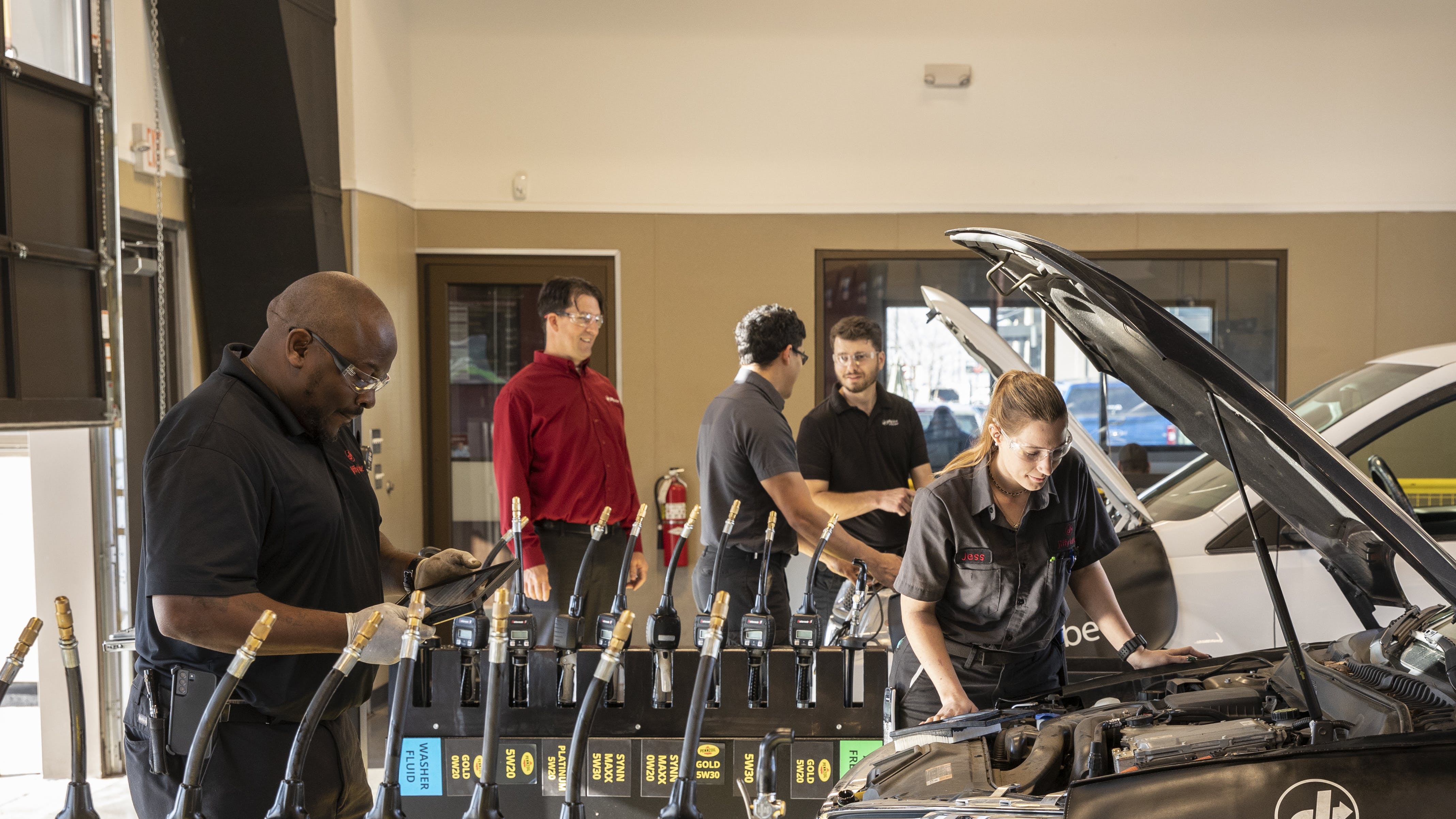 Chad Weisbeck (pictured in the red shirt) and team tackle tasks on the shop floor.