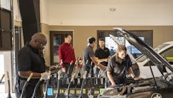 Chad Weisbeck (pictured in the red shirt) and team tackle tasks on the shop floor. Chad Weisbeck (pictured in the red shirt) and team tackle tasks on the shop floor.