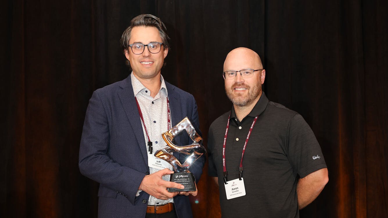 'Jeff Edwards, owner of DENT Quick Lube, accepts the 2024 Franchisee of the Year award from Jiffy Lube International, recognizing excellence in service, innovation, and community impact across 8 locations in Oregon and Washington.'